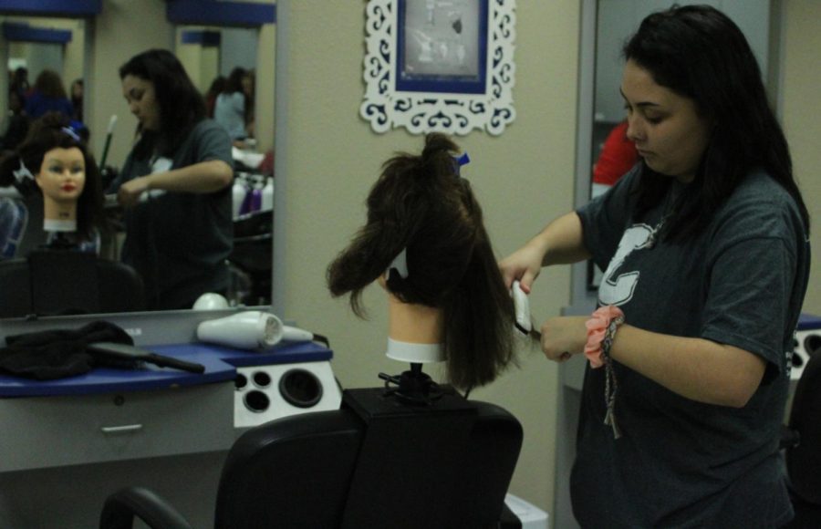 Senior Kyara Maldonado practices straightening hair Dec. 9 for the Skills USA Competition.