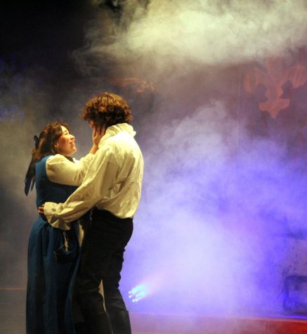 Belle, played by senior Ciara Carnes, and Beast, played by senior Luke Coonrod, share an intimate moment after their mutual love turns Beast human again.