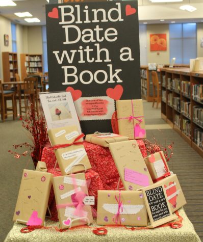 Wrapped books are displayed in the library for students to choose to read without seeing first. 