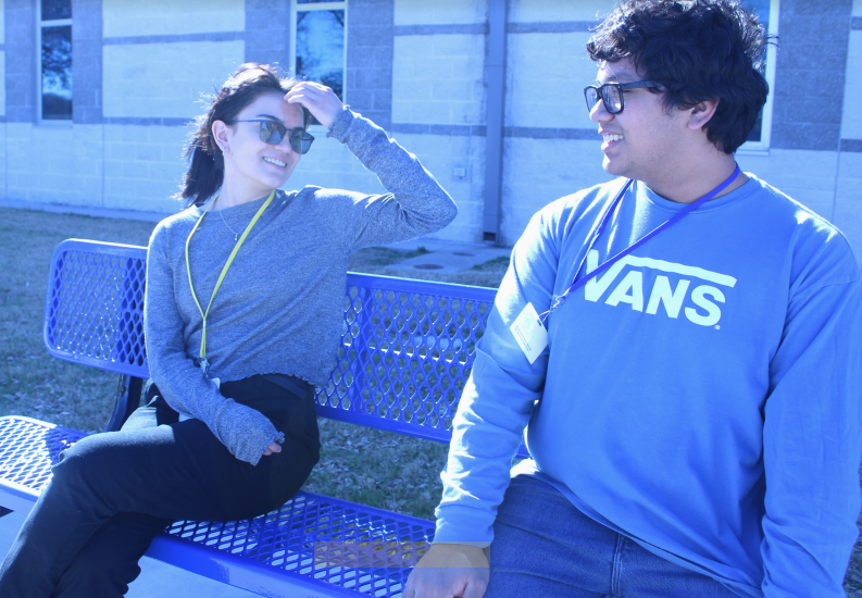Seniors Aryana Curtis and Todd Cameron sit on the new bench at the front of the school Jan. 12.