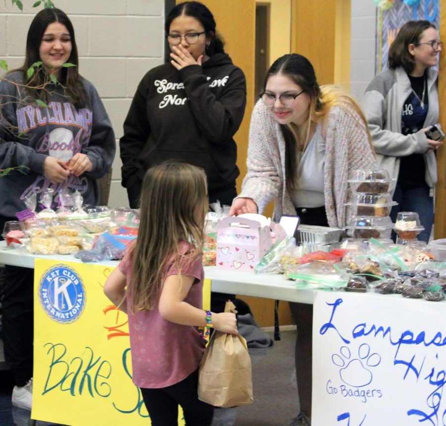 Key Club accounting manager Lulu Lopez sells baked goods at a fundraiser at the boys basketball game Feb. 14.