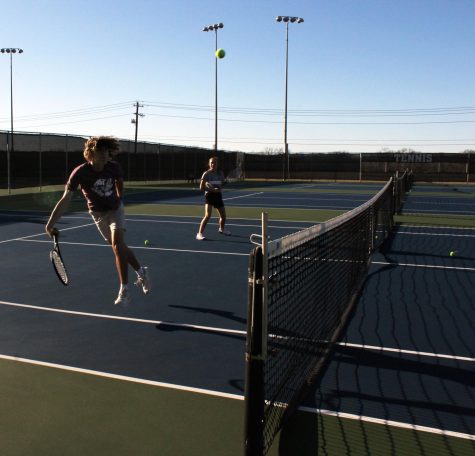 Senior Luke Rogers and sophomore Loretta Hodges practice tennis after school Feb. 22.