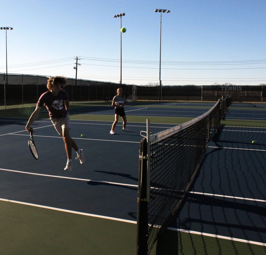 Senior+Luke+Rogers+and+sophomore+Loretta+Hodges+practice+tennis+after+school+Feb.+22.