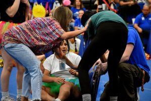 English I teacher Megan Achee assists sophomore Abrea Snow, while musical chairs competitor Karissa Perez realizes Snow's fingers are stuck in the folded chair.