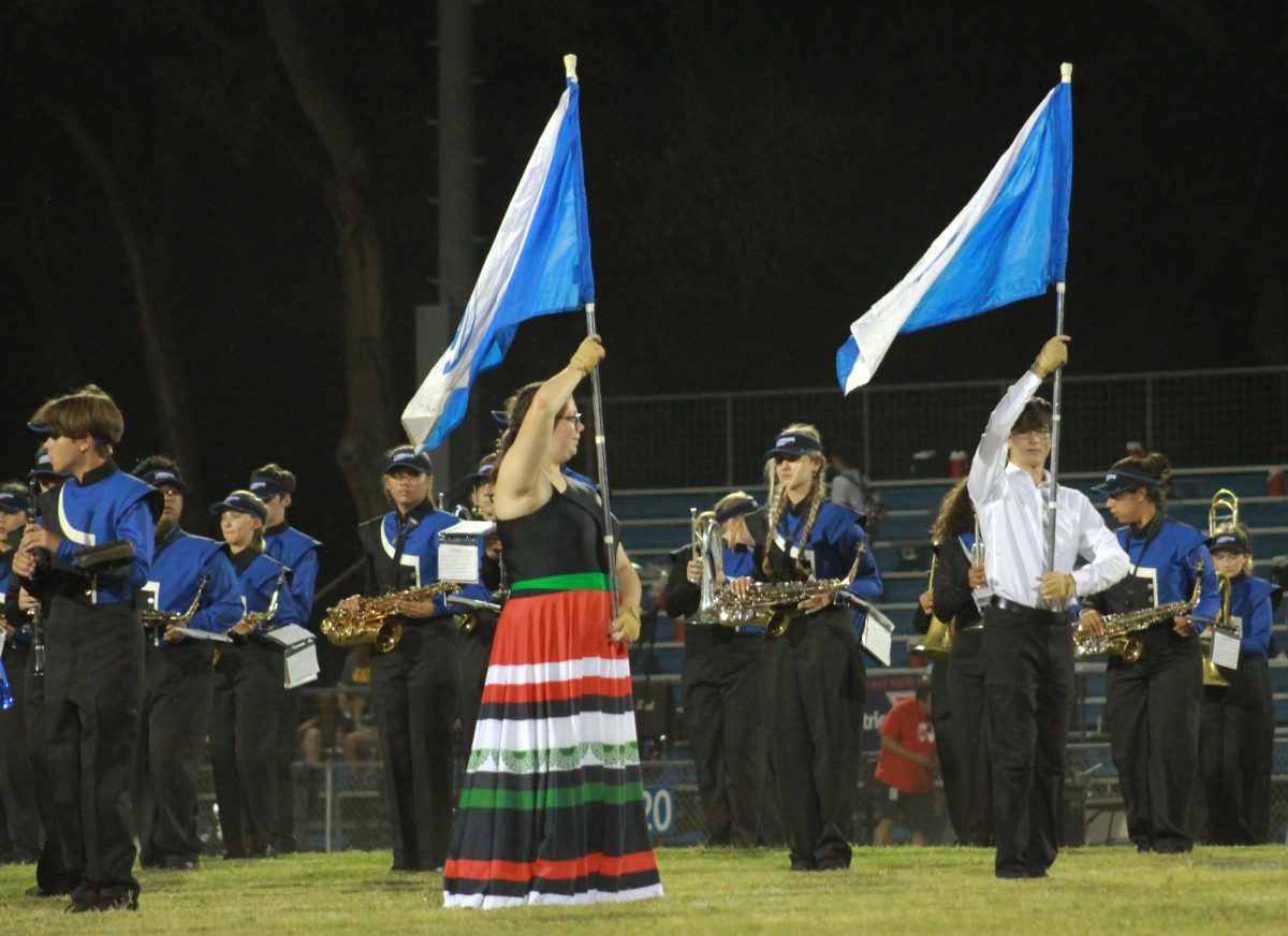 Colorguard performs in their Dia De Los Muertos costumes during Homecoming Sept. 8.