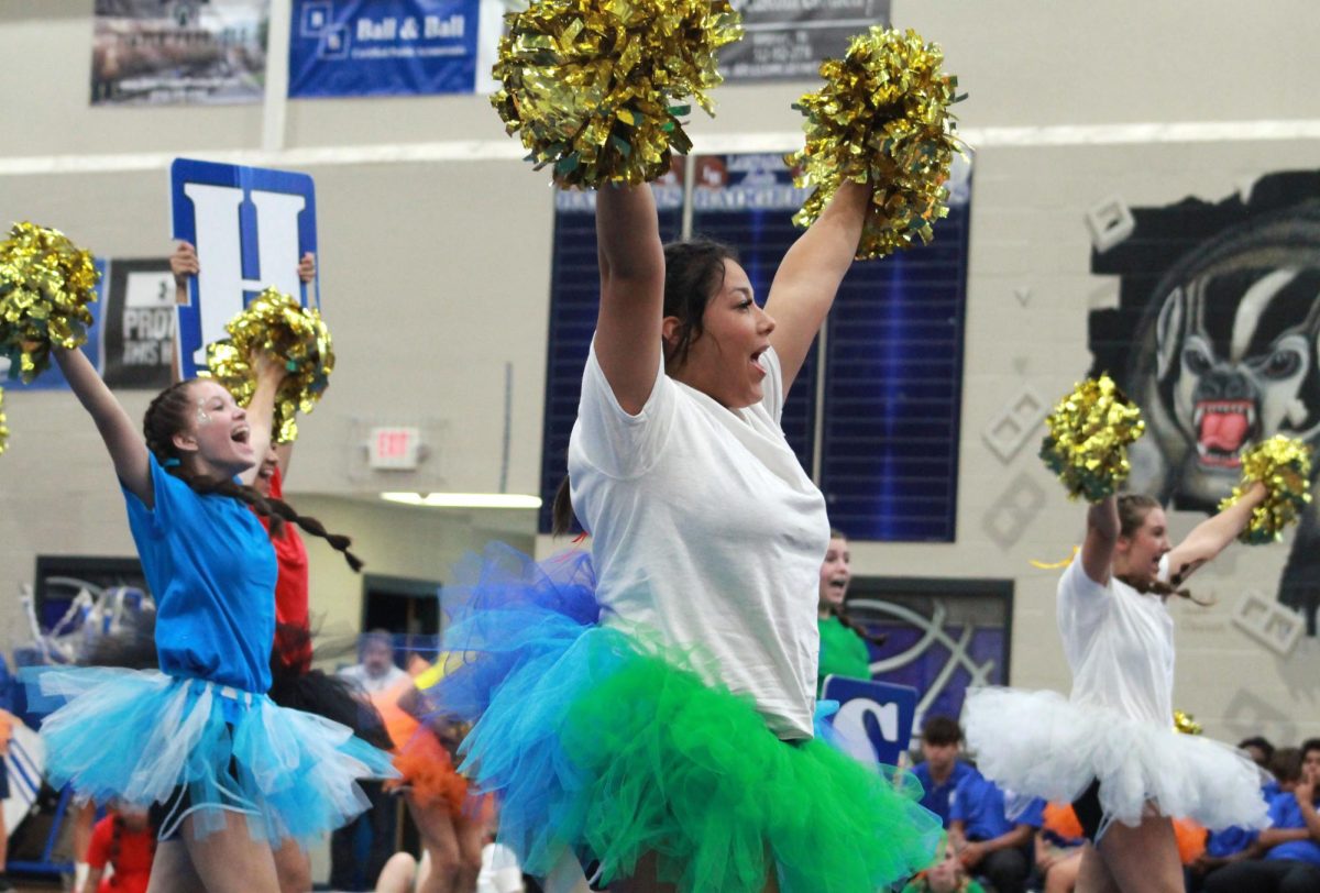 The cheerleaders, including senior Karissa Perez and sophomore Krista McManus, perform a cheer to replace the skit they had to cancel when the music cord plug was damaged. 