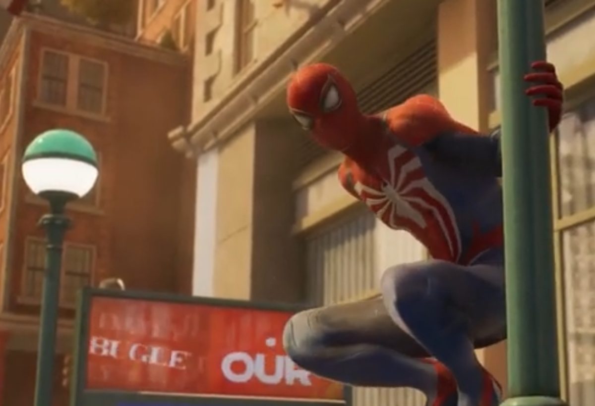 Spider-Man perches on a light post while helping out New York City.