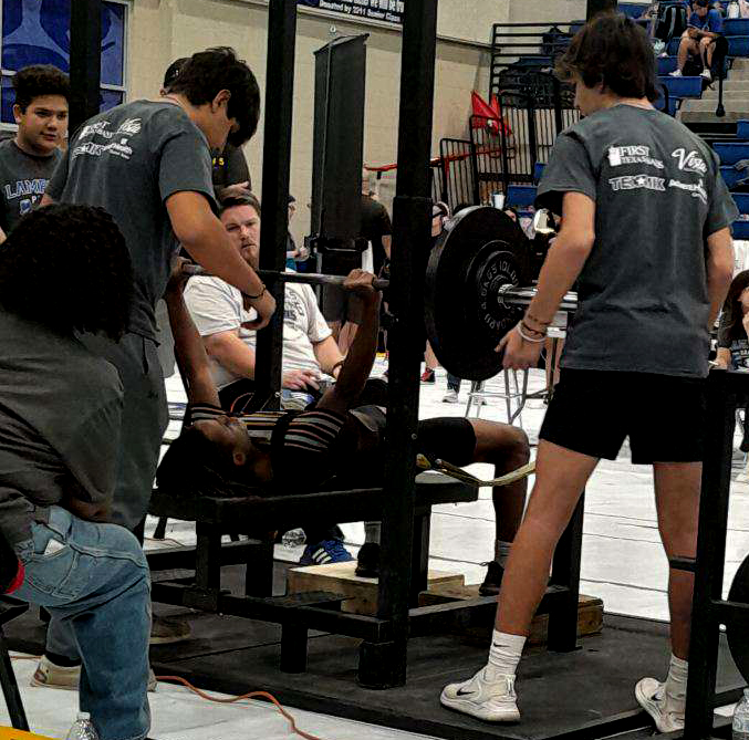 Junior Charles Mack bench presses during the power lifting meet Jan. 18.
photo courtesy of Macks mother
