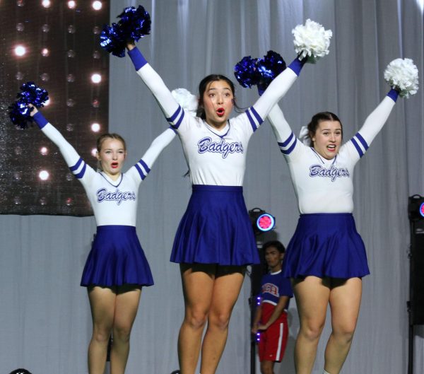 Freshman Tayler Sheard, sophomore Toby Brooks-Potter and sophomore Chandler Boultinghouse compete in finals at the National Cheer Association High School Nationals Jan. 21. 
