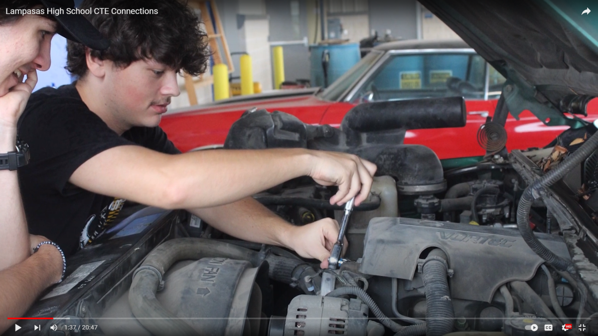 This still from the CTE Connections video shows students working on an engine as part of the automotive program. 