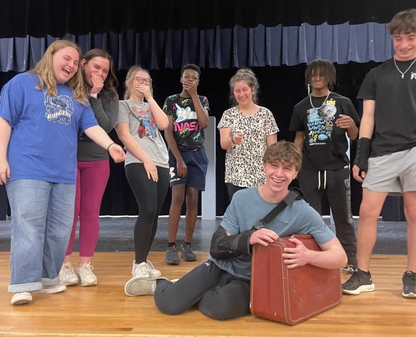 One Act students laugh together after practicing scenes during rehearsal.