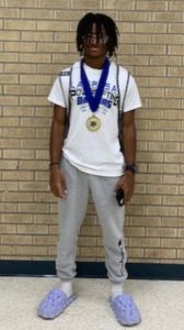 Junior Charles Mack wears his gold medal from the powerlifting regional meet.