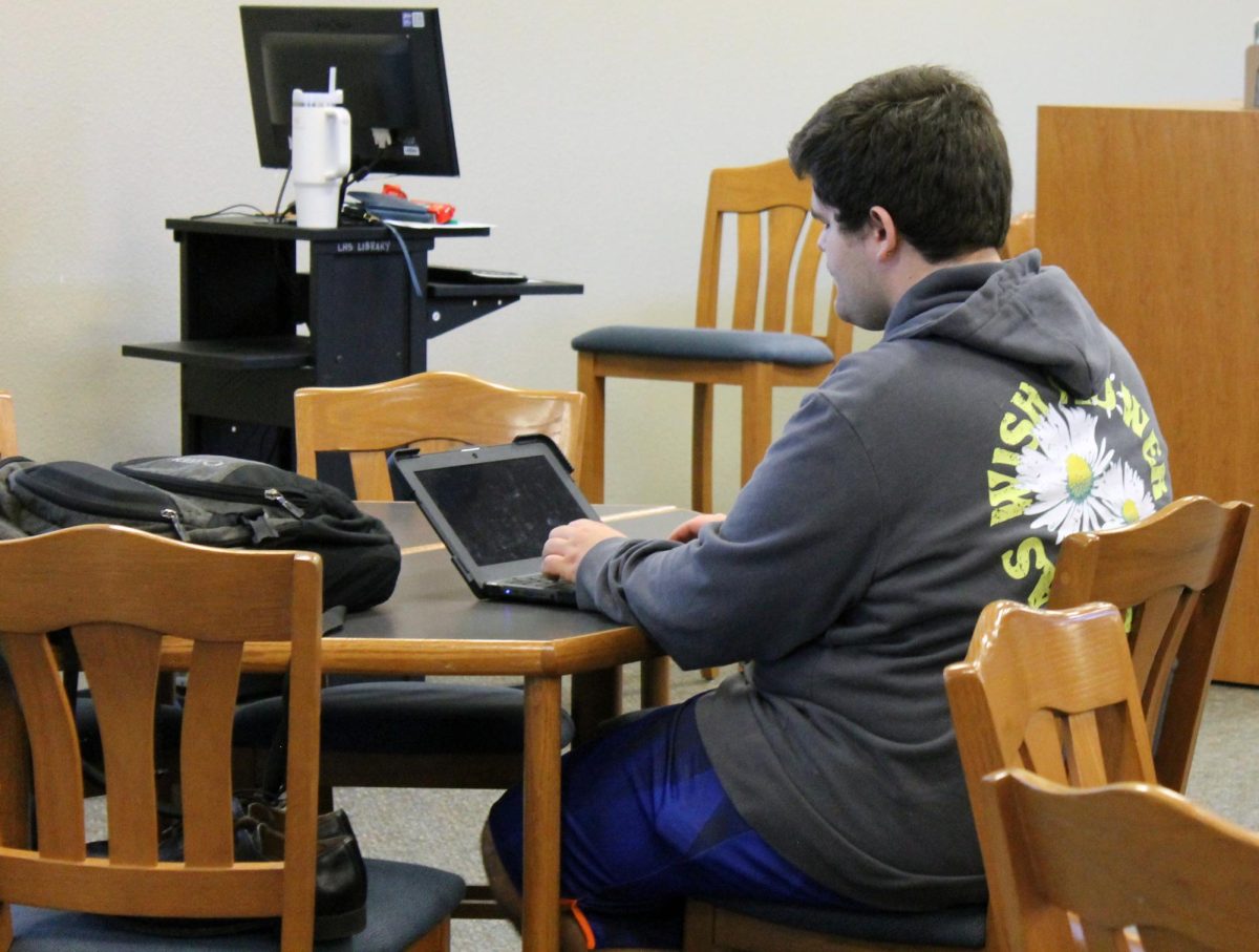 Senior Dylan Duvall takes notes during English II teacher Desiree Kachels Adulting 101 session about budgeting May 3.