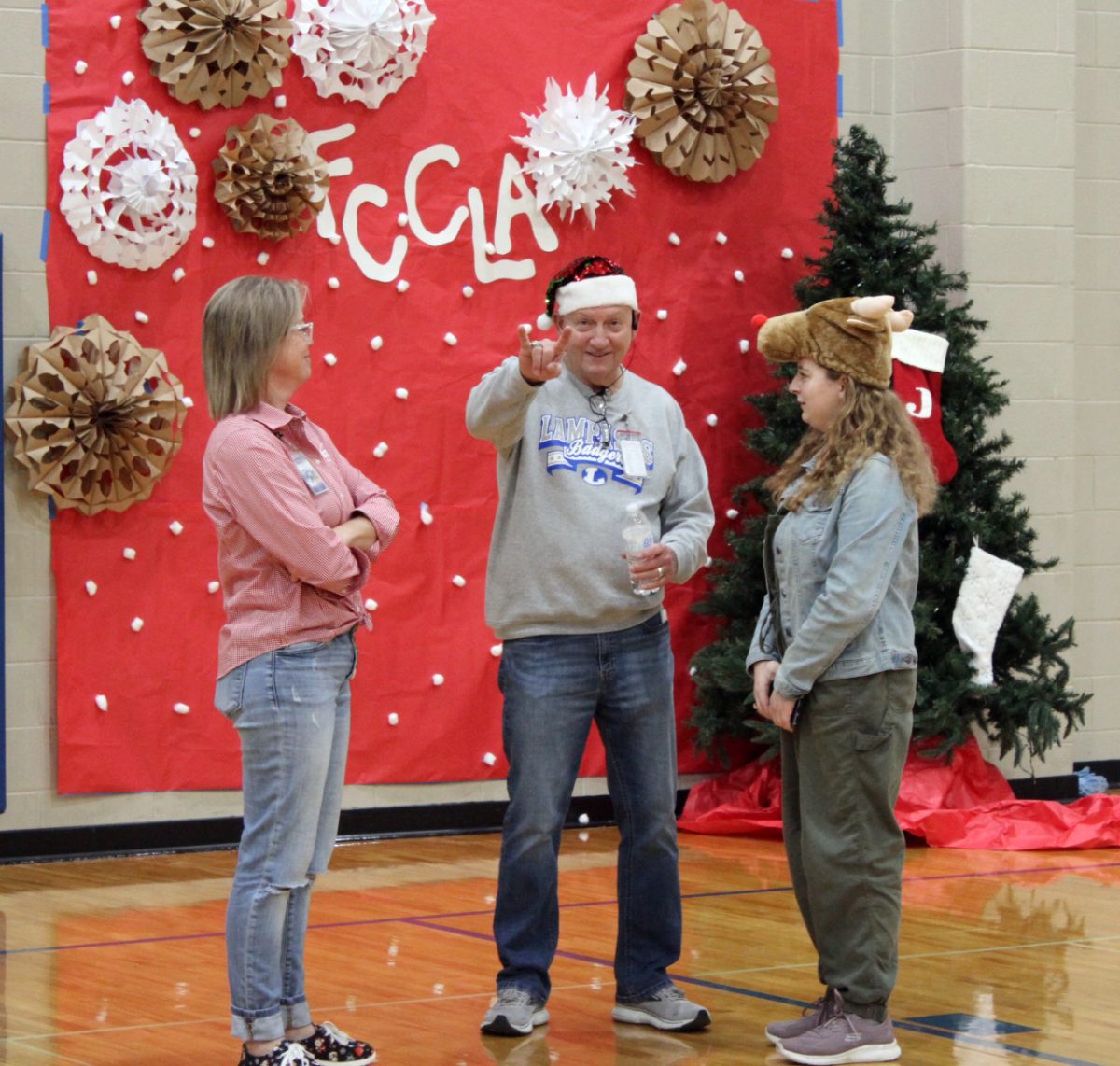Principal Joey McQueen participates at FCCLA Angle Tree gift donation party.