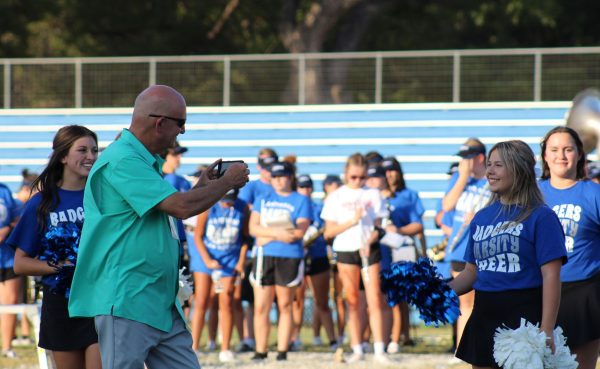 Principal Joey McQueen takes photos at the 2023 Homecoming community pep rally.