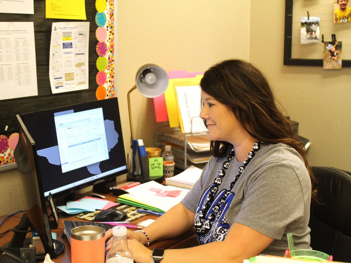 Hooten adjusts to new tasks, including checking students grades on Skyward.