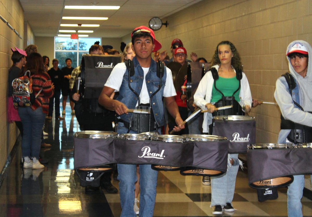 Junior Juan Rodriguez and other percussionists march through the hall first period Oct. 31. 