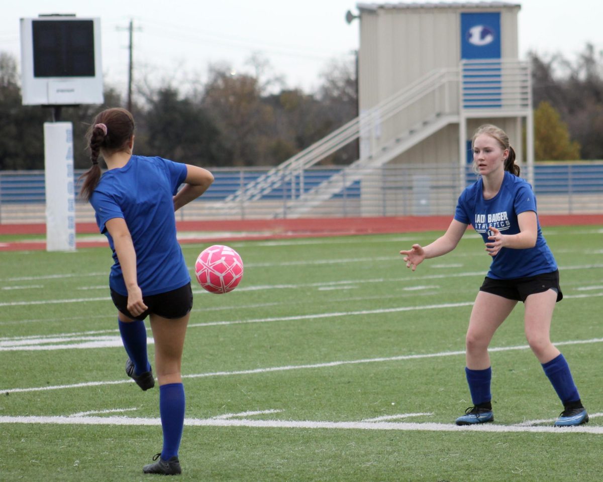 Freshmen Eden Gibson and Soleya Southerly practice passing drills at girls soccer tryouts Dec. 3.