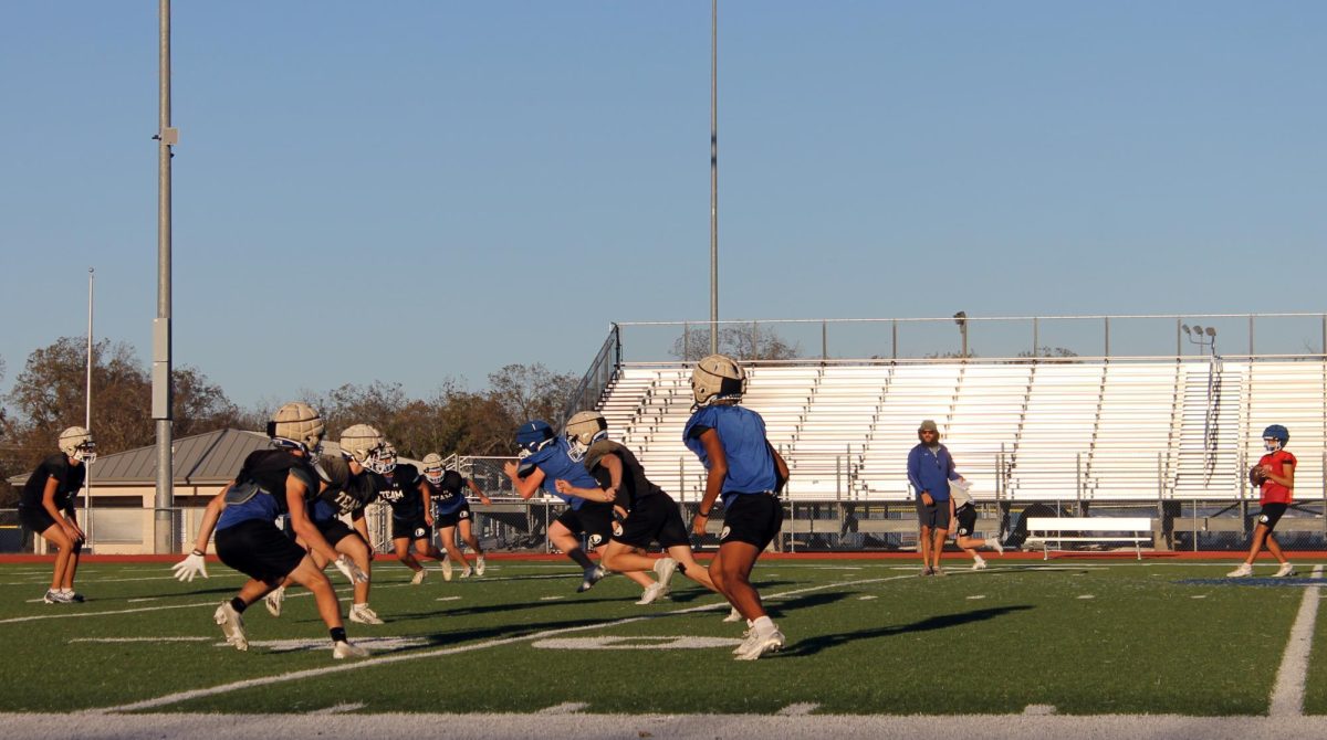 Varsity football team practices with Junior Varsity football team after school Nov. 19. 