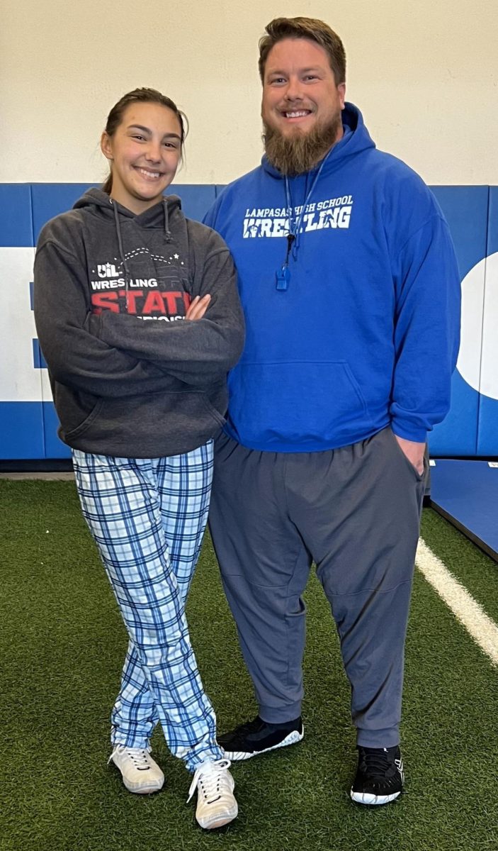 Senior Charlie Freese takes a break with coach Donovan Kleckner in the weight room before school Jan. 21.