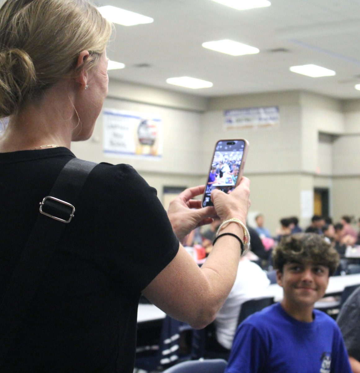 Assistant principal Kristin Montague takes a photo of a student for the LHS Facebook page during lunch Monday. 