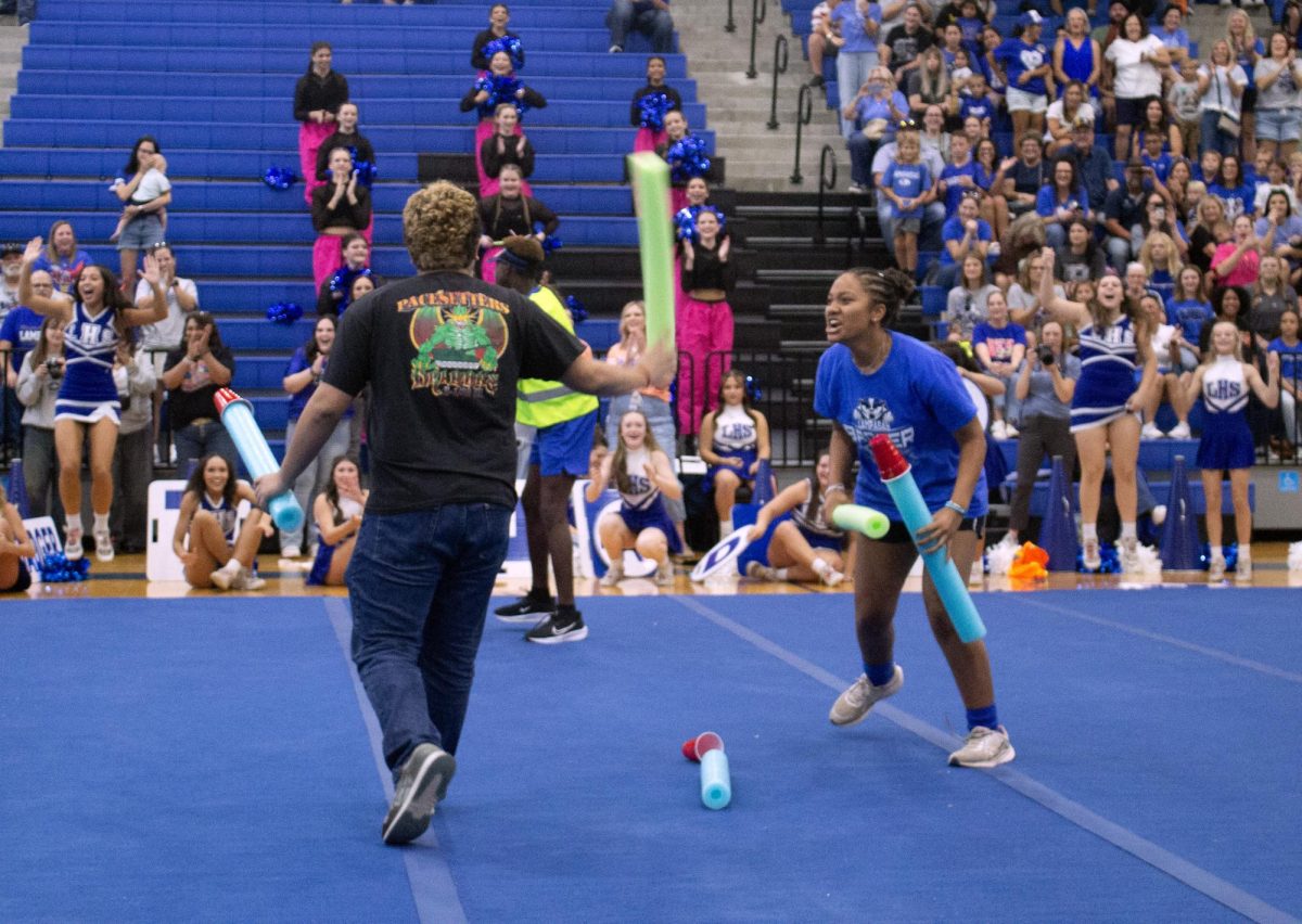 Senior class president Kaira Toeaina and senior class vice president Armando Cardona III compete for the top position in the student council game. The seniors won the game against the other classes.