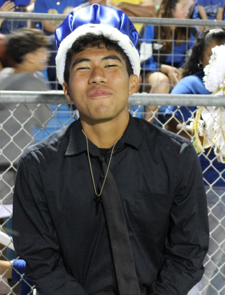 Senior Juan Rodriguez waits on the sidelines during halftime for homecoming queen to be announced.