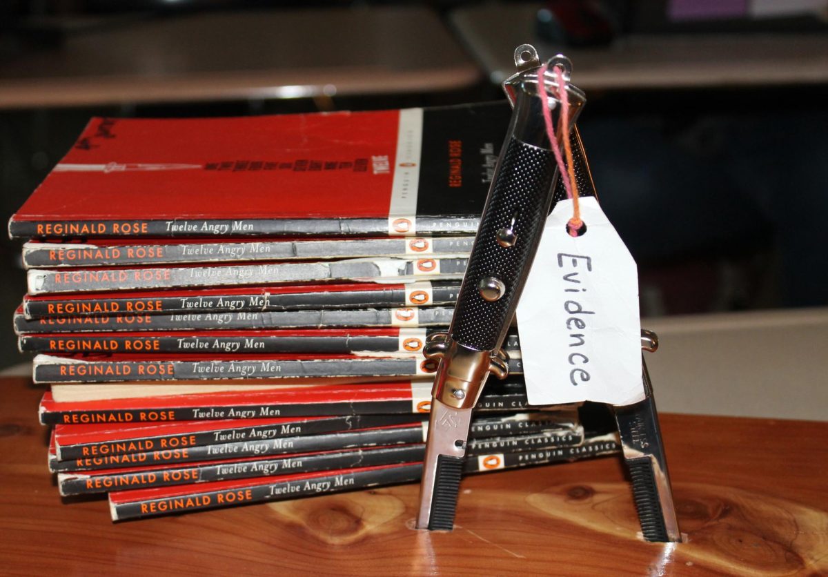 English I teacher Kayla Cain uses two "switchblade combs" to represent the switchblade knives stabbed into the table in the play Twelve Angry Men.
