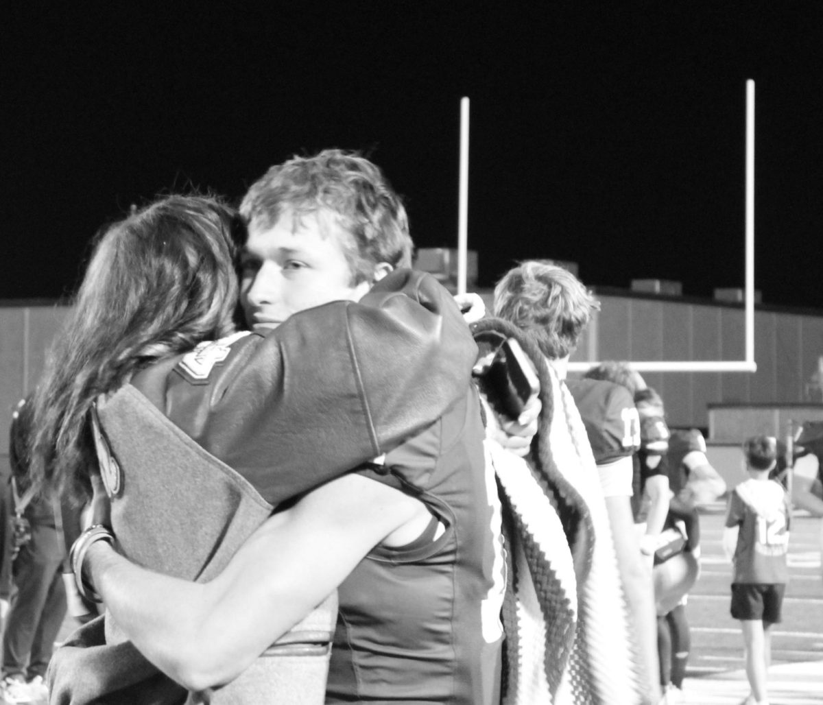 Sophomore Alyssa Teal and Sean Smith hug after the game Nov. 21.