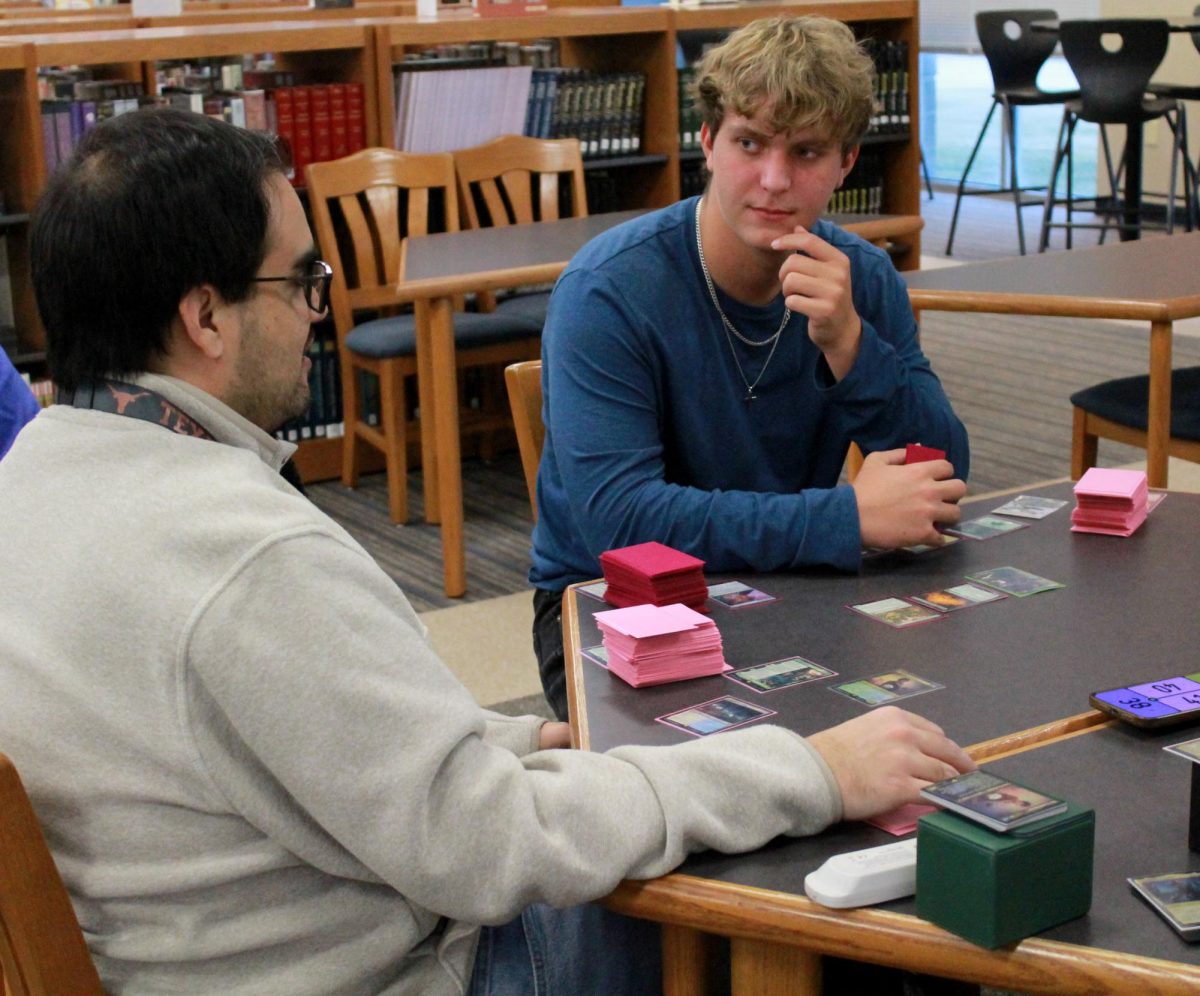 Brayton and senior Gabriel Garrett play Magic: The Gathering during Magic club after school.