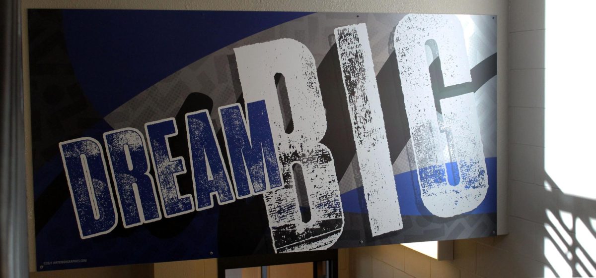 A sign in the stairwell saying to "dream big". 