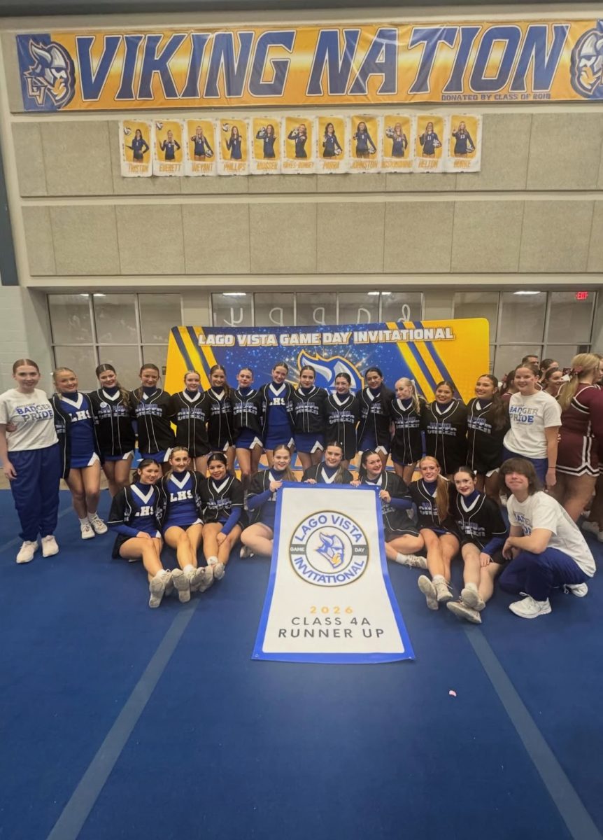Cheer team with their Runner Up sign at the Lago Vista Tournamnet Jan. 4. Courtesy of Brynn Huner.