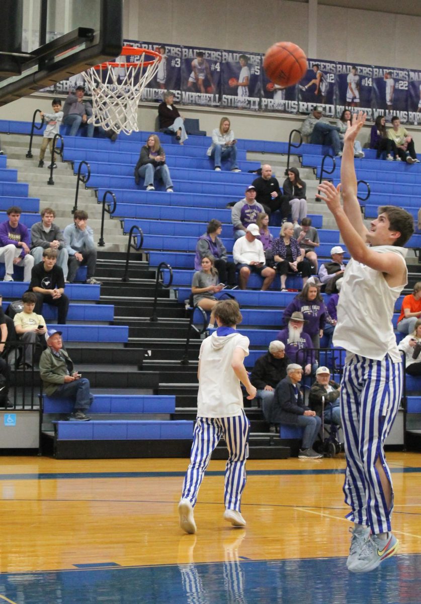Senior Calum Mitchell shoots a basket before a game Jan. 13.